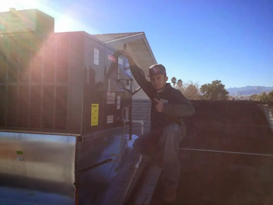 HVAC technician performing Heat Pump Repair on a rooftop unit in Wadsworth